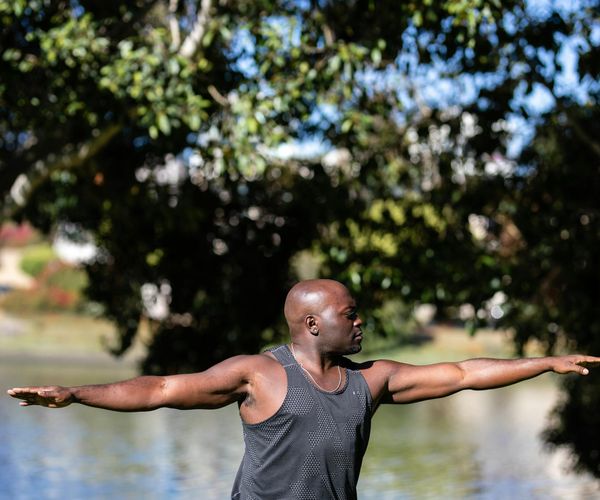Person stretching outdoors, symbolizing vitality and energy.